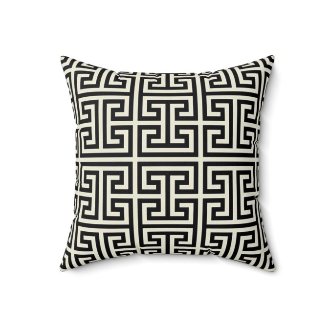Black-and-white square throw pillow with a repeating Greek key pattern.