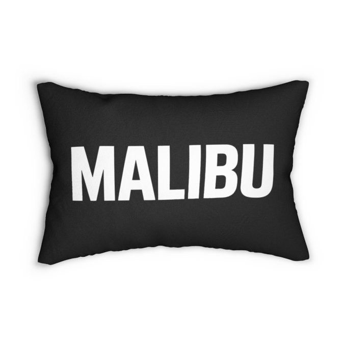 Black lumbar pillow with bold white MALIBU lettering.