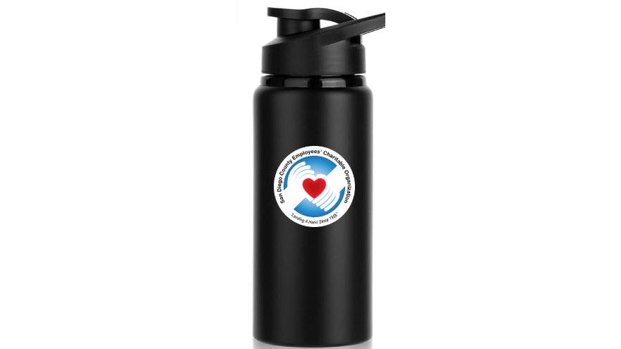 A professional hand holding a stainless steel water bottle with a custom logo, with other colorful plastic bottles blurred in the background on a table