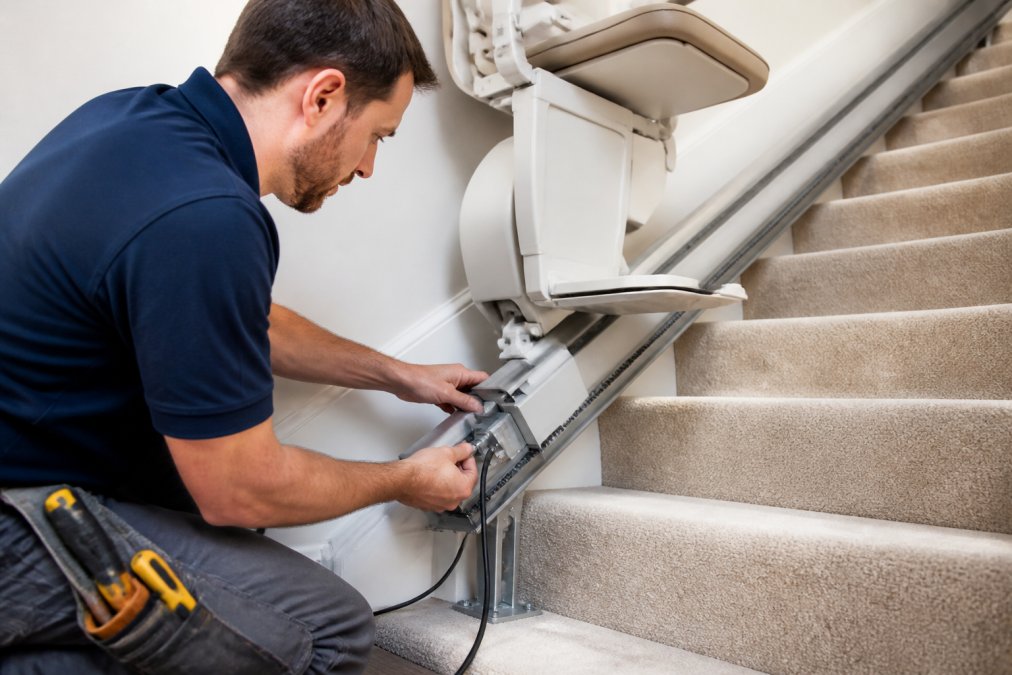Electrician connecting the power supply to meet stairlift electrical requirements during a residential installation