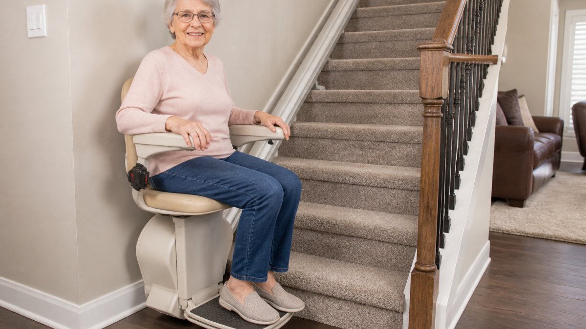 Older adult seated securely in a stairlift with safety features, helping you decide on stairlift rental vs buying.