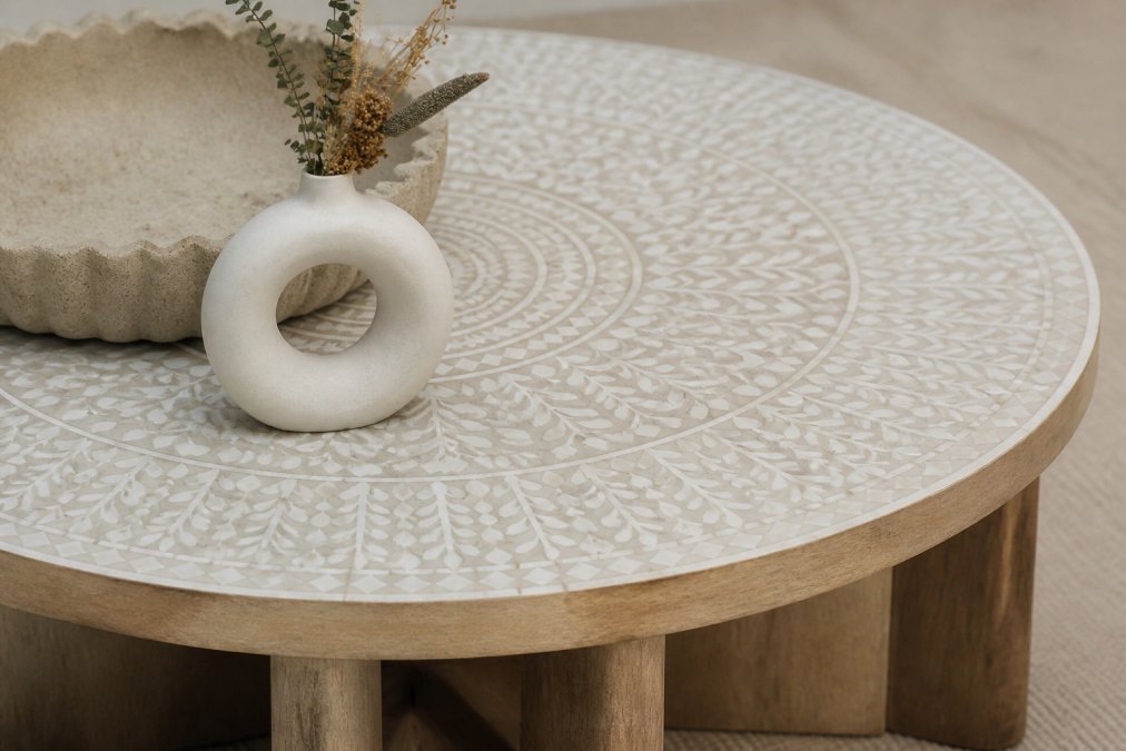 Close-up of bone inlay coffee table with mango wood frame showing intricate hand-inlaid details and natural wood grain texture