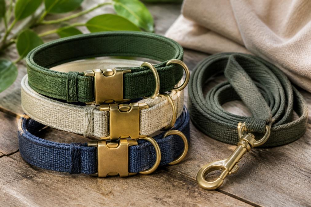 Close-up of sustainable pet gear materials including recycled fabric textures, durable brass hardware, and eco-friendly collars arranged to showcase craftsmanship and material quality
