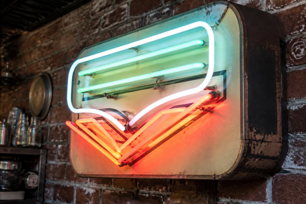 Infographic diagram showing how rarity and condition affect the market value of vintage neon signs