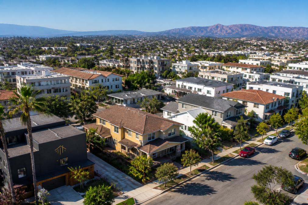 Aerial view of a residential neighborhood featuring diverse homes, ideal for analyzing real estate investment benefits.