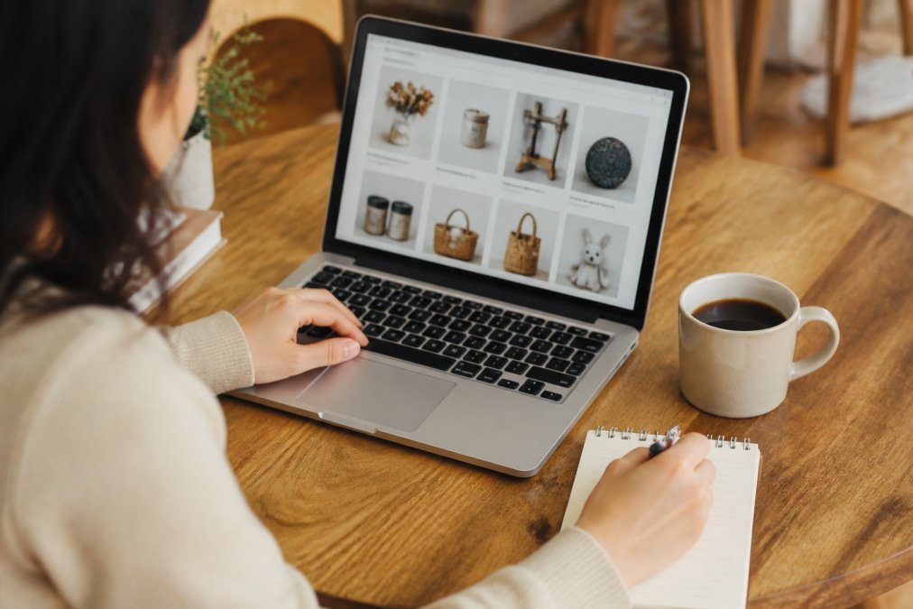 Person browsing an online store on a laptop, a perfect uncommon goods alternative for finding unique gifts.