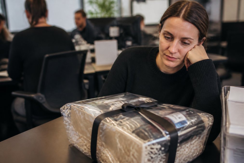 An unopened food hamper left on a desk, representing failed client gifts.