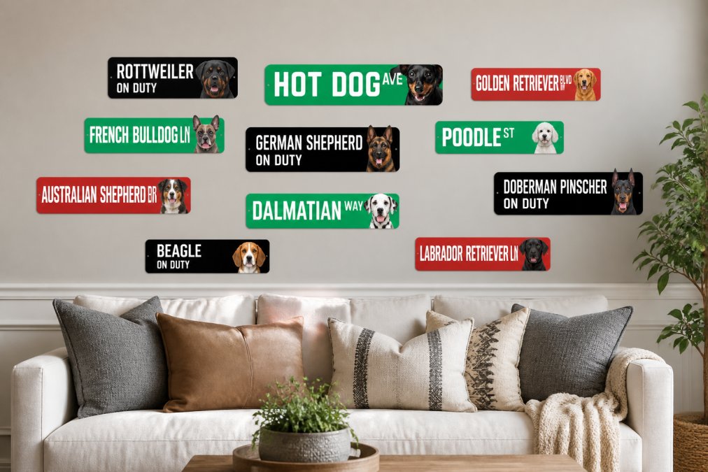 A living room wall displaying multiple dog breed metal signs arranged in an attractive gallery wall pattern, with different sized street signs and on-duty signs positioned at varying heights to create visual balance and rhythm, complementing modern farmhouse furniture and neutral wall color