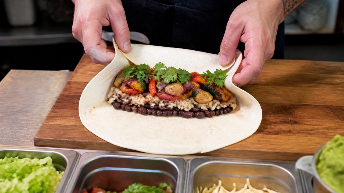 Step-by-step guide for wrapping vegetarian burrito recipes with rice, beans, and roasted vegetables.