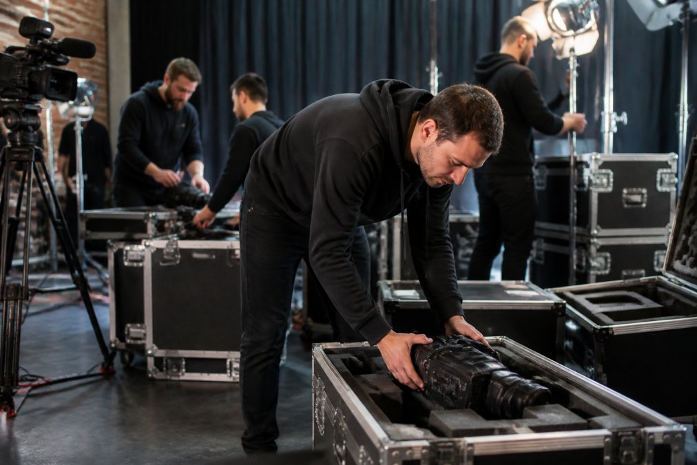 A professional production team adjusting camera angles and lighting levels in a studio control room before a live product launch broadcast