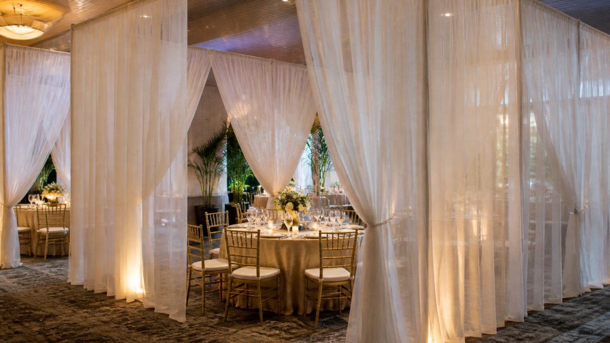 Flowing voile fabric dividers creating a soft, romantic atmosphere at professional voile fabric events.