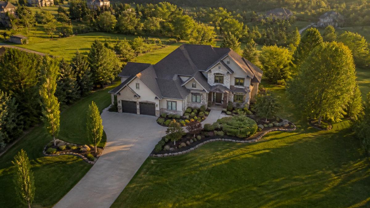 Aerial view of a suburban property at golden hour, highlighting the value of drone services real estate photography.