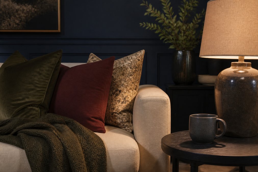 Infographic showing how navy, burgundy, and olive tones create visual depth in a moody living room corner