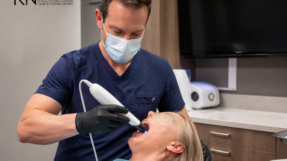 Dentist using an intraoral scanner to create a 3D model, part of what is the process for dental veneers.