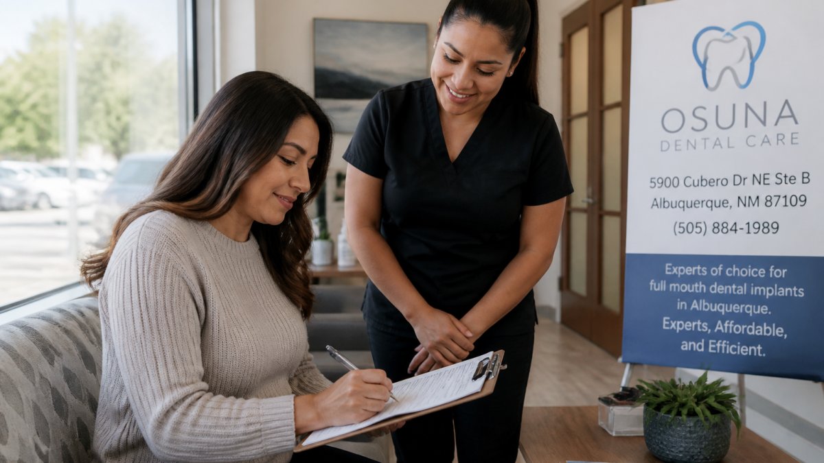 Patient sitting in bright, modern dental office waiting room, completing new-patient paperwork on a clipboard with a friendly dental assistant nearby, natural lighting from windows