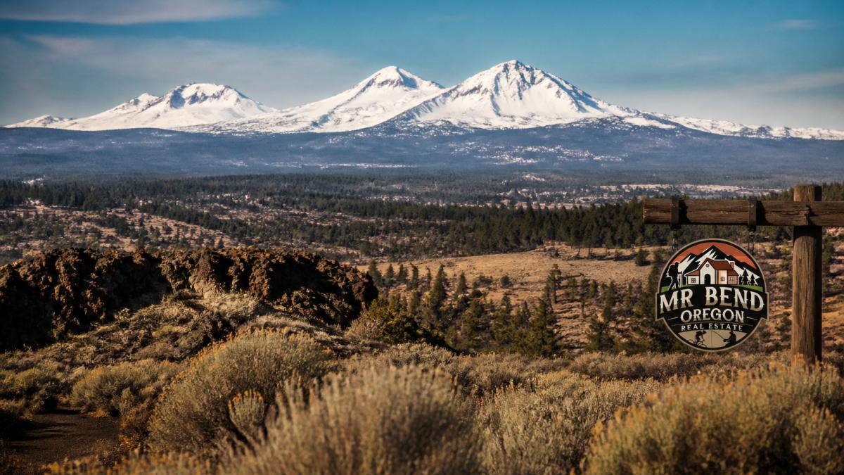 Snow-capped Cascade Mountains rising over the high desert landscape while moving to Deschutes County.