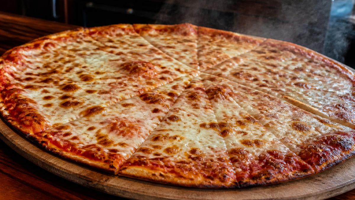Steaming 24-inch Jersey-style thin crust pizza in Breckenridge with crispy edges and melted mozzarella.