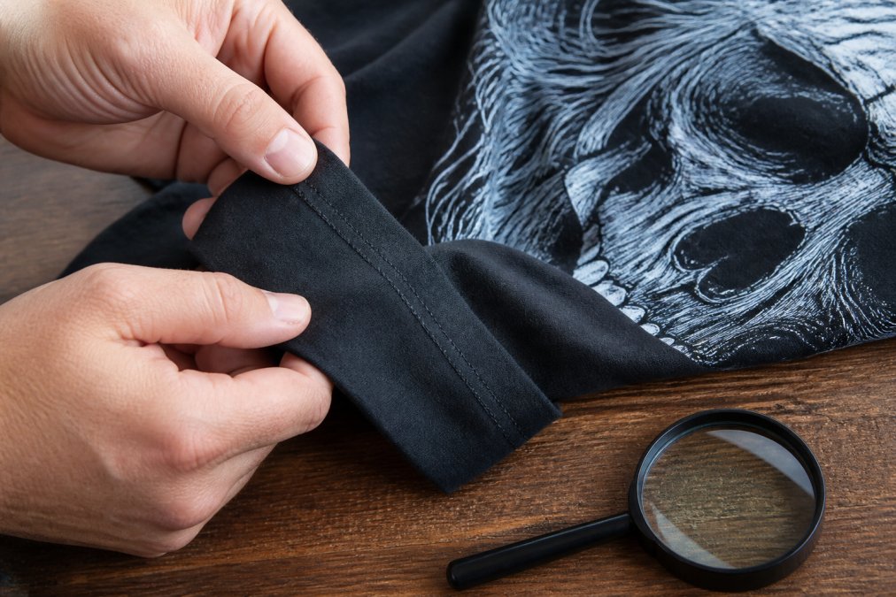 Infographic demonstrating how to inspect fabric and print quality of US-made graphic shirts before purchasing
