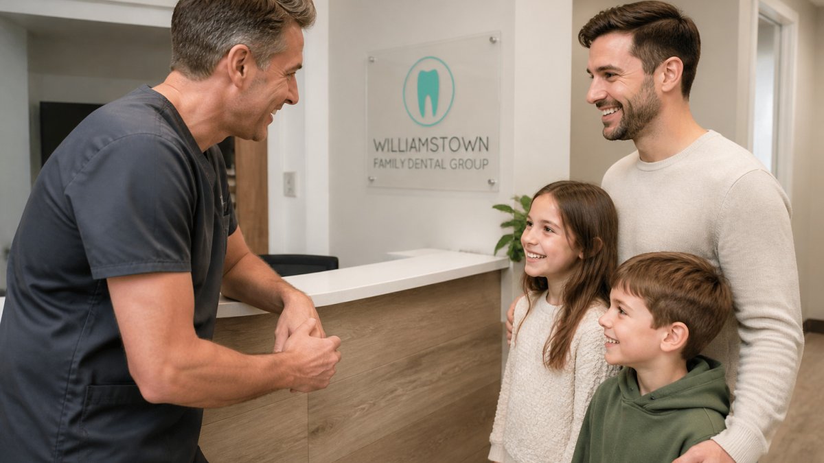 A dentist greeting a father and his children at our local dental practice reception.