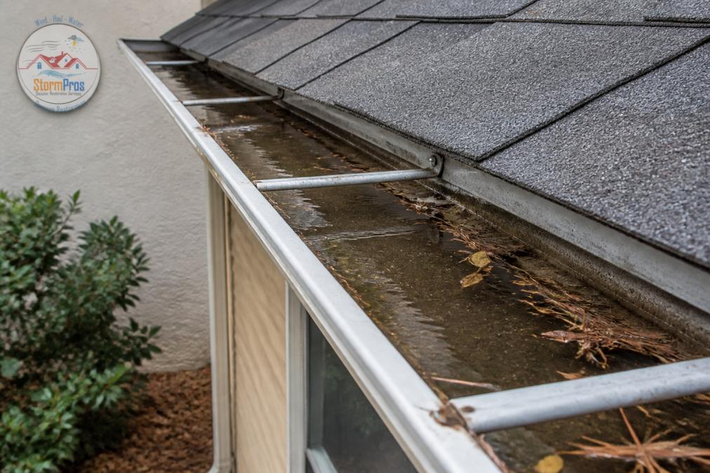 Diagram showing how debris and sagging pitch cause why gutters overflow during light rain due to pooling water.
