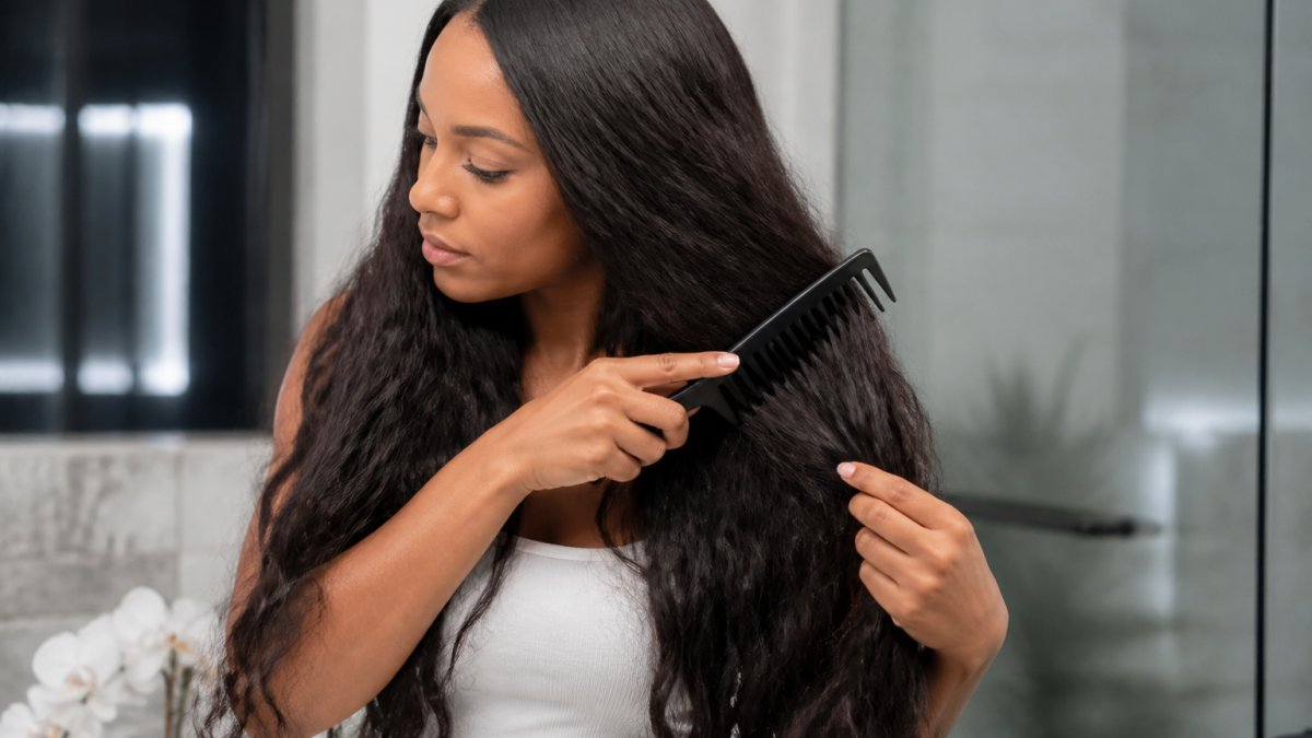 Step-by-step guide on using a wide-tooth comb to prevent hair extensions get matted while brushing.