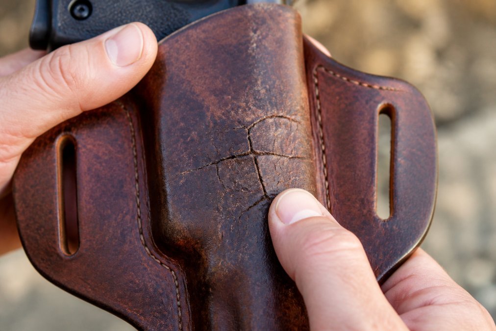 Infographic showing how leather holsters crack due to stress and wear
