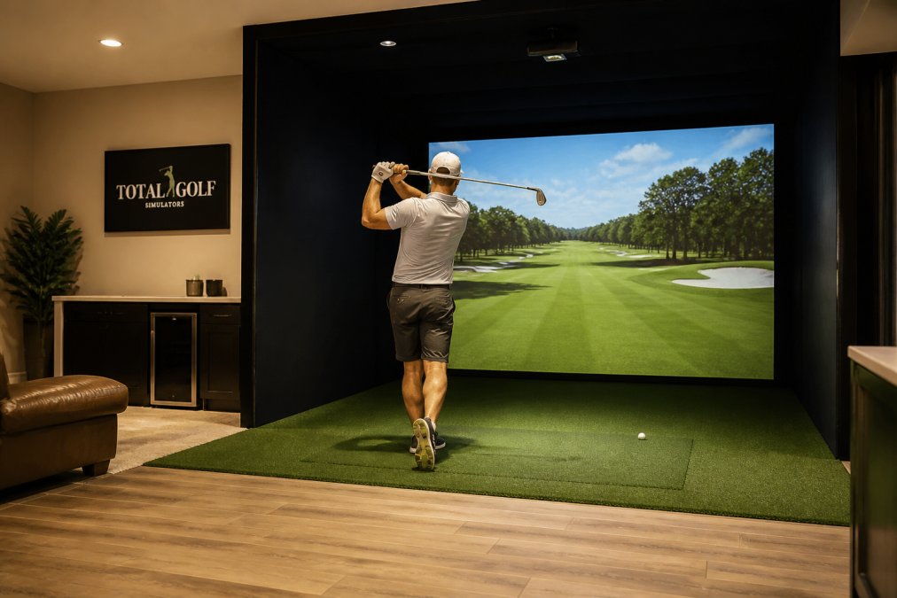 Golfer hitting a ball in a home room with professional golf simulator installation and high-quality screen
