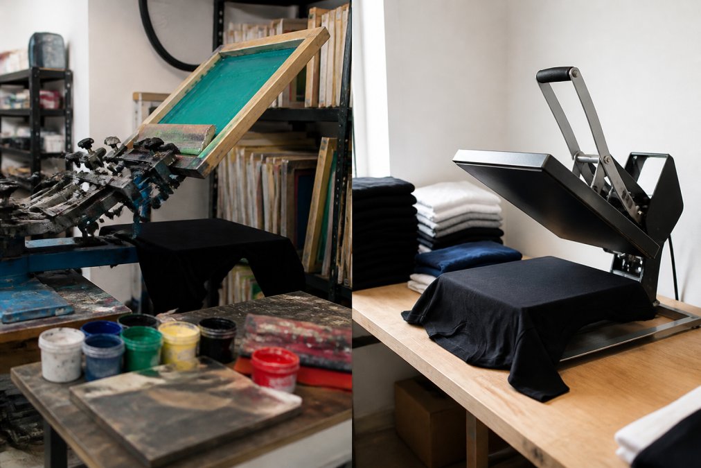 A workspace with professional screen printing equipment visible, showing mesh screens, ink containers, and a heat press setup with organized production materials