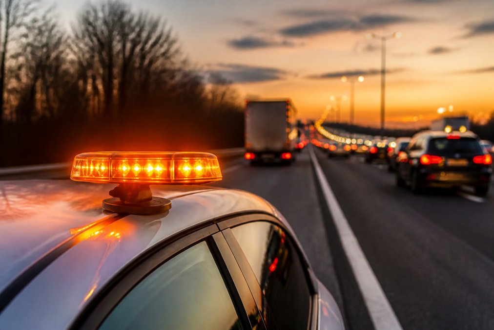 Why Visibility Is Crucial for Stationary Vehicles Bright LED hazard beacon on a car roof warning traffic of stationary vehicles at dusk on a motorway.