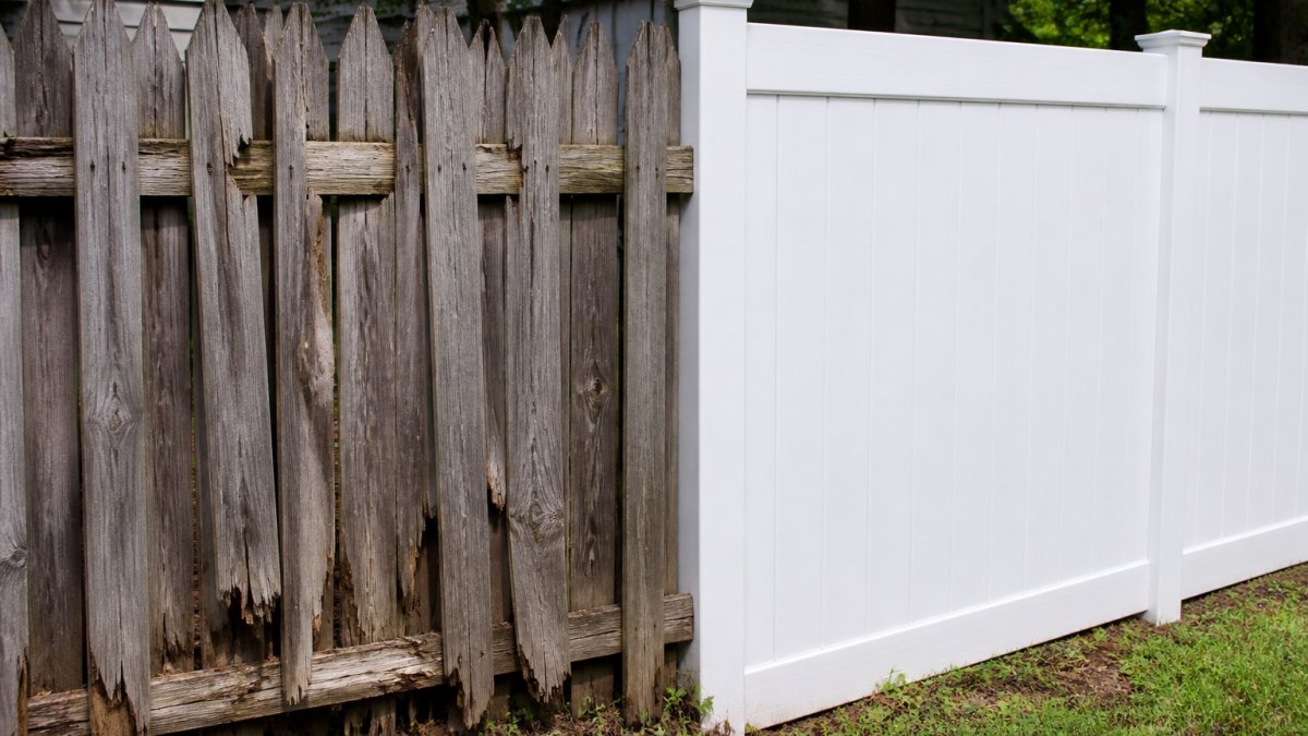 Weathered wood fence showing visible rot, warping, and splintering damage from moisture and sun exposure next to a vinyl fence in similar conditions showing minimal visible wear