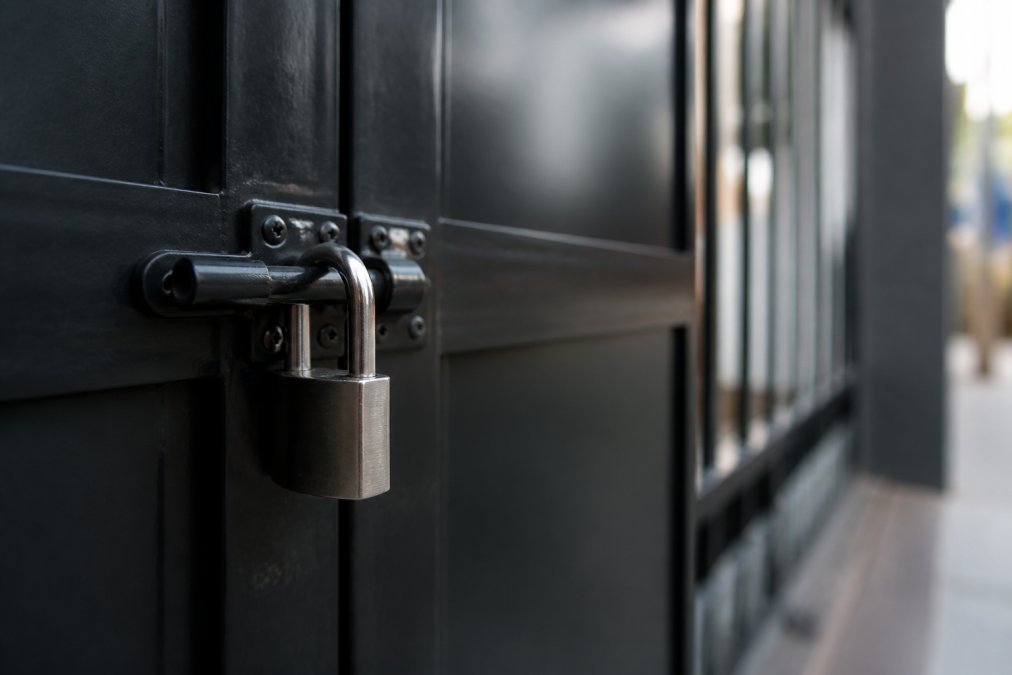 Close-up of a padlock icon on a computer screen with a secure checkout page visible in background, representing encrypted online transaction security with soft blue lighting